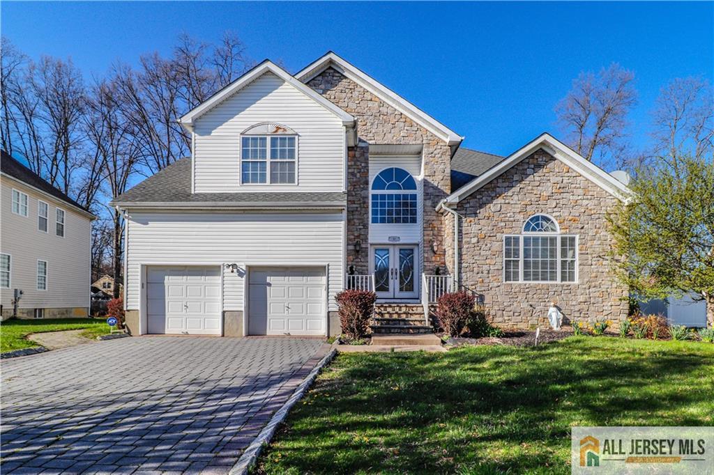 a front view of a house with a yard and garage