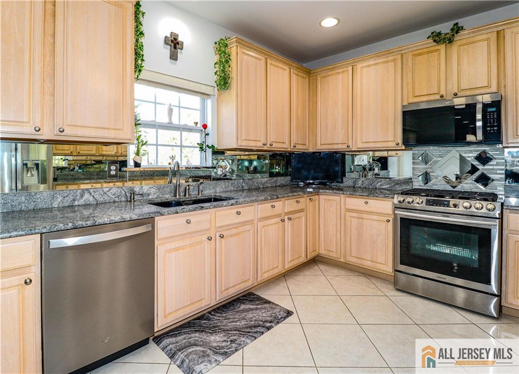 11 Markham Circle Old Bridge, NJ 08857 - Photo 13 of 61 a kitchen with stainless steel appliances granite countertop a stove a sink and a microwave