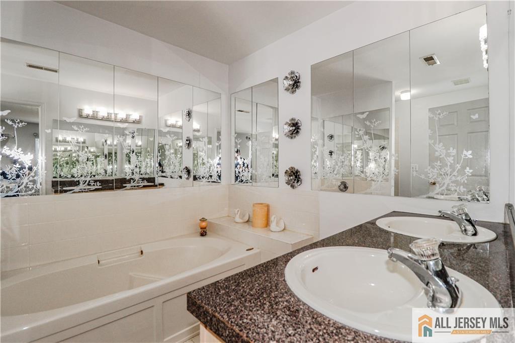 11 Markham Circle Old Bridge, NJ 08857 - Photo 33 of 61 a bathroom with a tub a sink and a large mirror