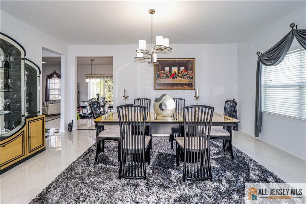 11 Markham Circle Old Bridge, NJ 08857 - Photo 10 of 61 a dining room with furniture a chandelier and wooden floor