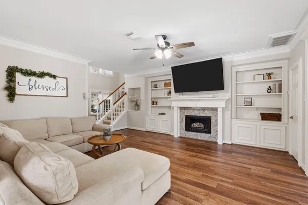 a living room with furniture a flat screen tv and a fireplace