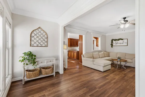a living room with furniture and wooden floor