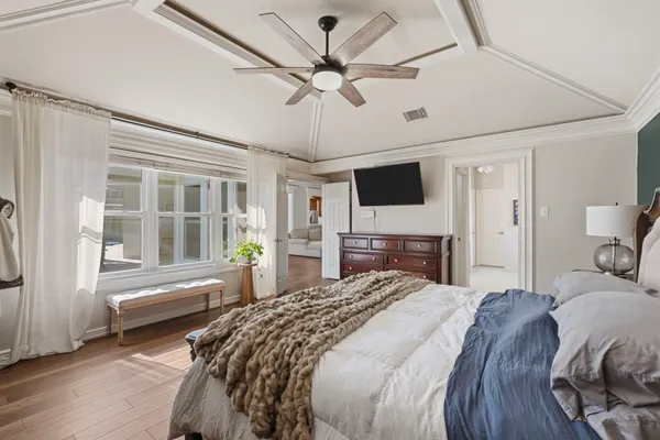 a bedroom with a bed and a chandelier