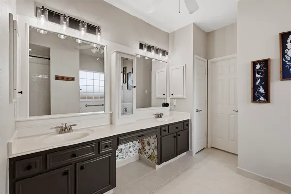 a bathroom with a double vanity sink mirror and double