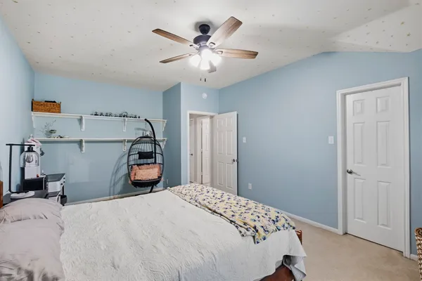 a bedroom with bed and car