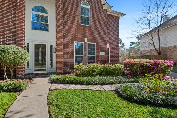 a front view of a house with garden