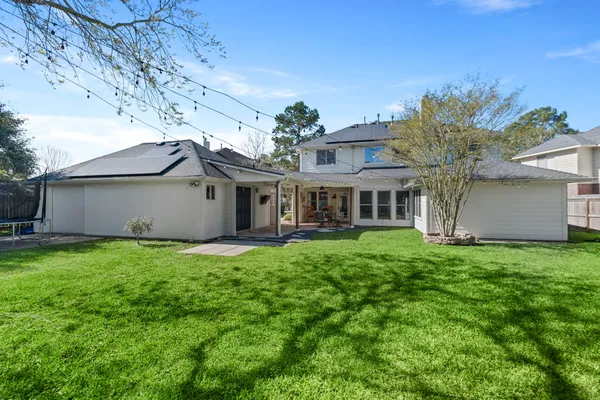 a view of a house with a backyard
