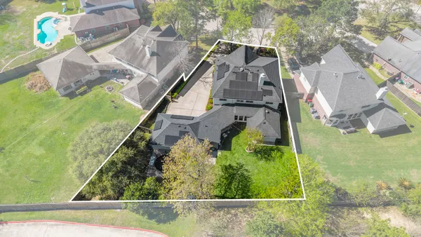 an aerial view of residential houses with outdoor space