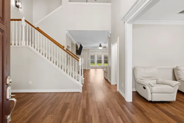a living room with furniture and a wooden floor