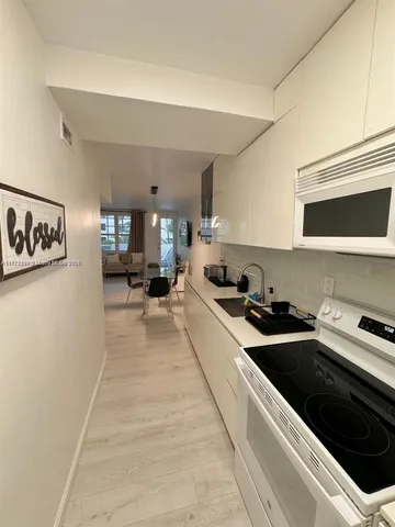a kitchen with stainless steel appliances a stove a sink and a refrigerator