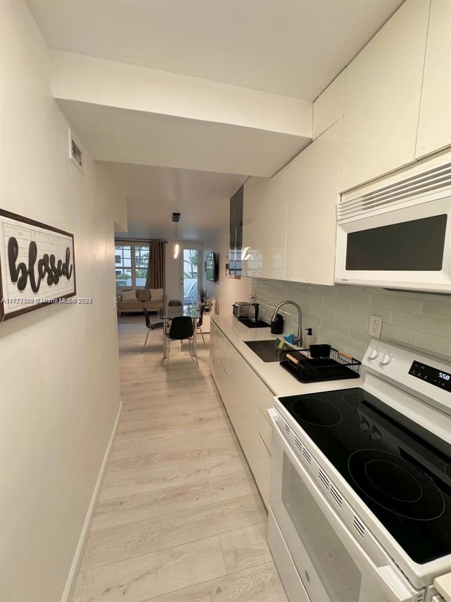 100 Lincoln Road, Unit 430 Miami Beach, FL 33139 - Photo 1 of 21 a kitchen with stainless steel appliances a stove a sink and a refrigerator