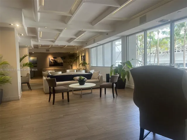 a living room with furniture gym equipment and a large window