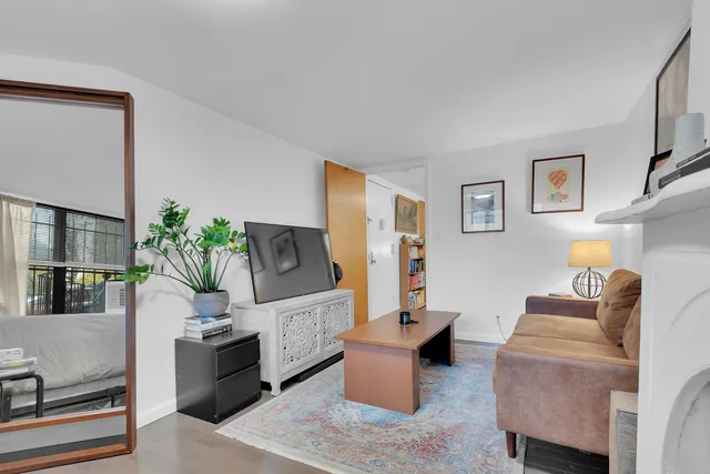 a living room with furniture a mirror and a lamp