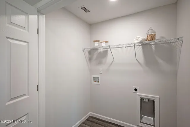 a large kitchen with stainless steel appliances lots of counter space and wooden floor