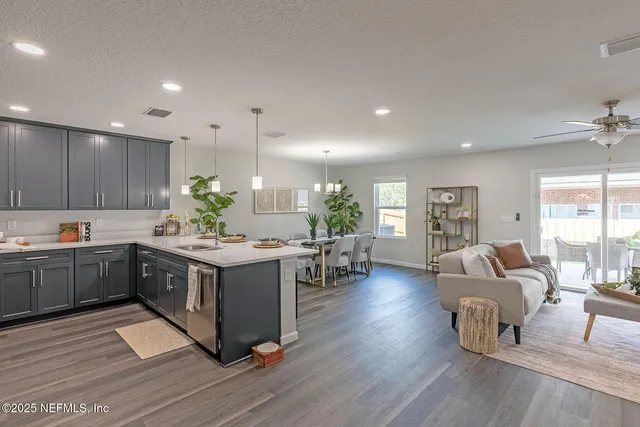 a kitchen with kitchen island granite countertop lots of counter top space and stainless steel appliances