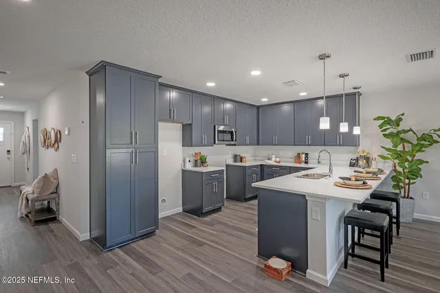 a kitchen with sink and cabinets