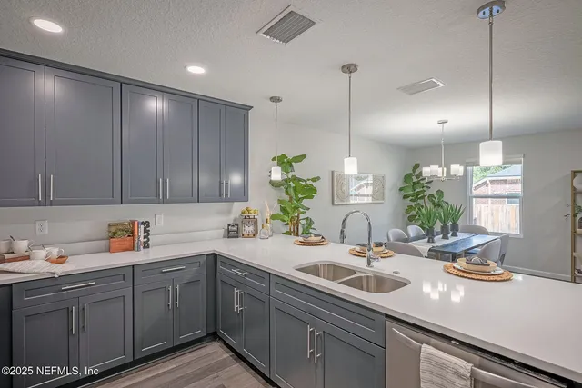 a kitchen with a refrigerator a sink and chairs