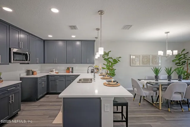a dining room with furniture a potted plant and a chandelier