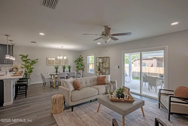 a bedroom with a bed dresser and window