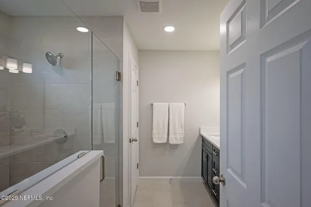 a white toilet sitting next to a white cabinet