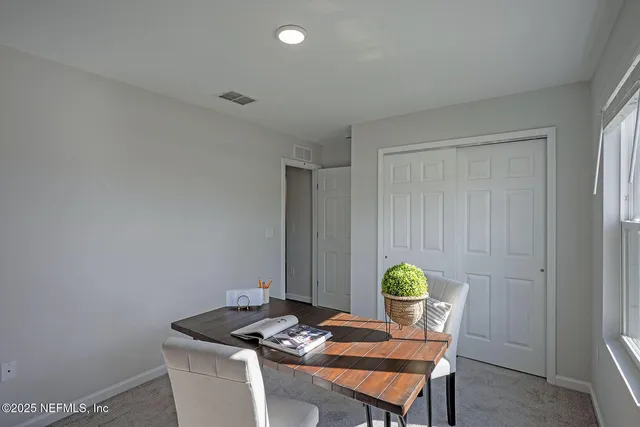 a living room with furniture and next to a window