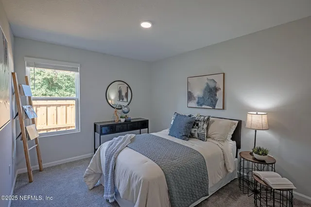 a bedroom with a bed and a painting on the wall