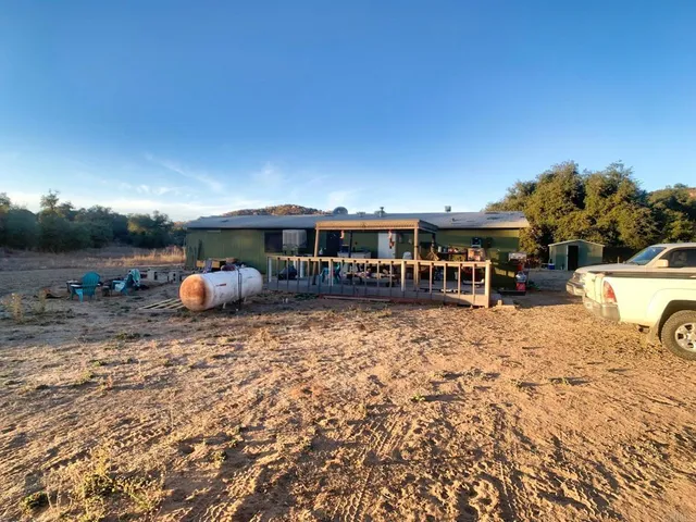 a view of a yard with a snow in the background