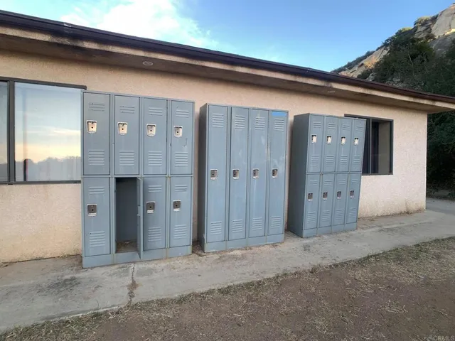 a view of a pathway with wooden floor next to a building
