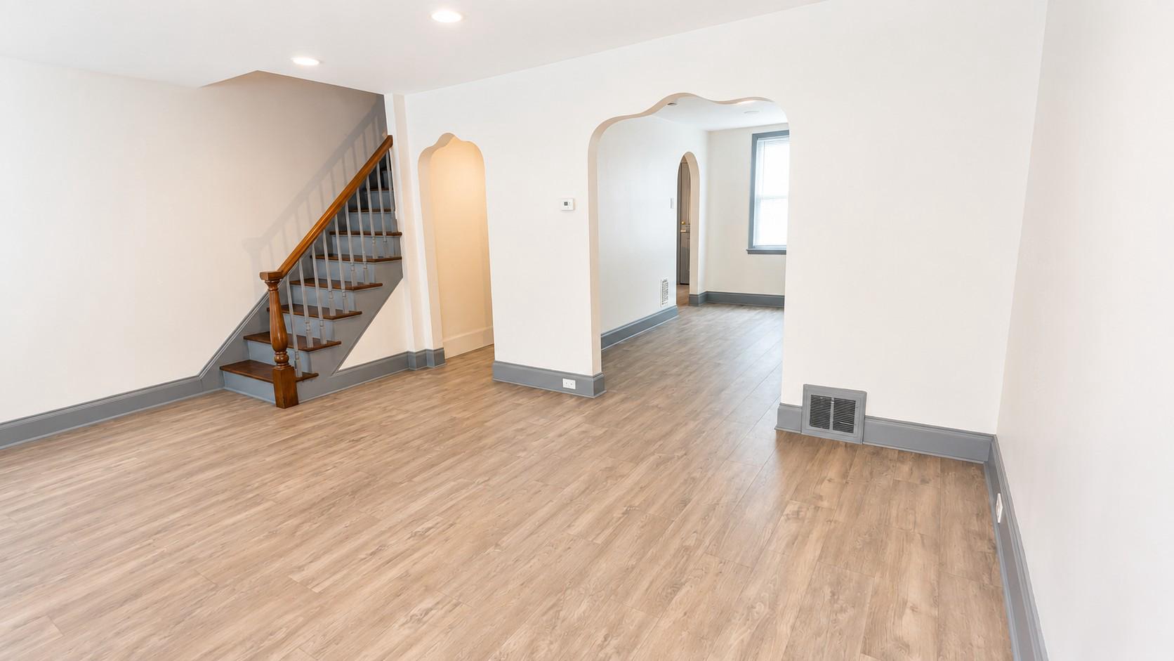 2909 Yorkship Road Camden, NJ 08104 - Photo 4 of 26 a view of an empty room with wooden floor and stairs