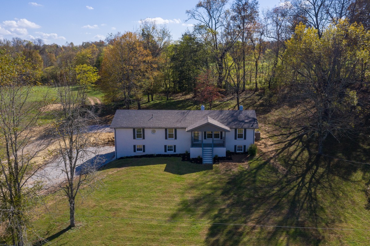 300 Garrison Branch Road Cottontown, TN 37048 - Photo 1 of 50 a view of a house next to a yard with a large tree
