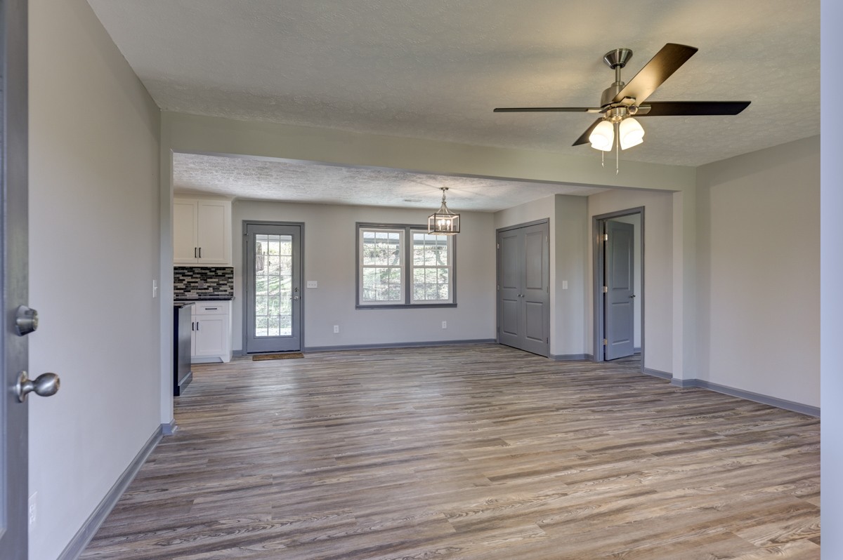 300 Garrison Branch Road Cottontown, TN 37048 - Photo 12 of 50 a view of empty room with wooden floor and fan
