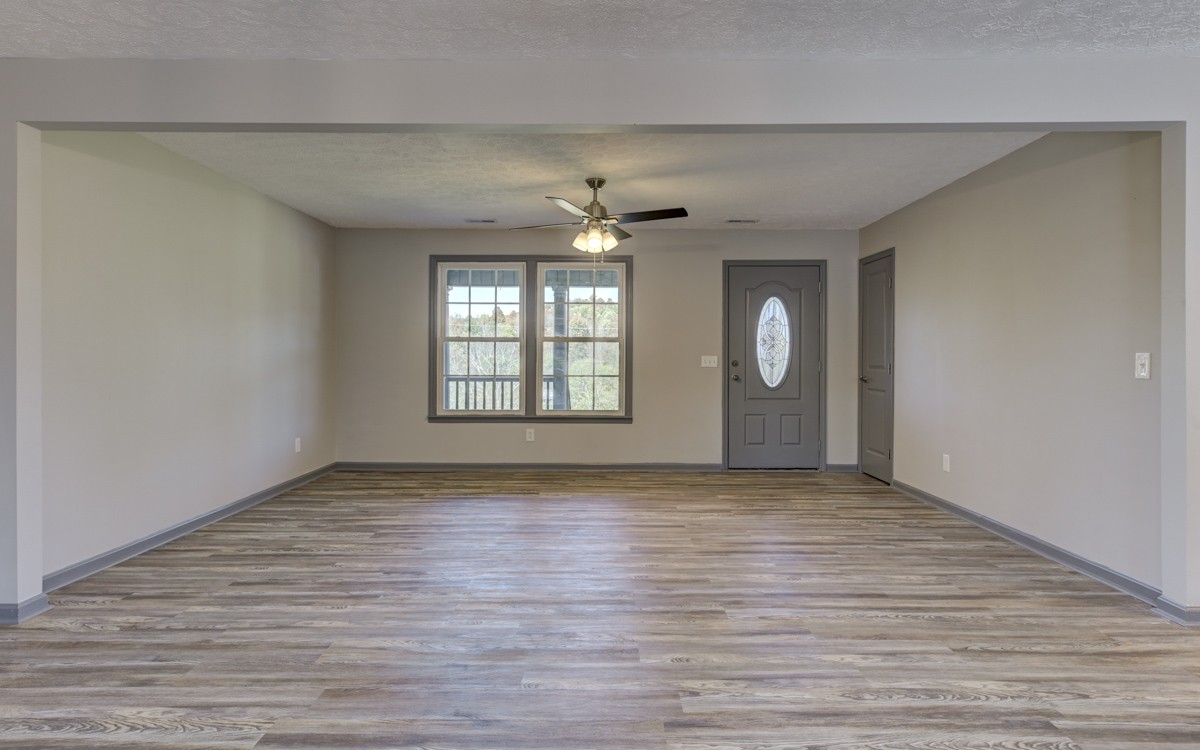 300 Garrison Branch Road Cottontown, TN 37048 - Photo 13 of 50 wooden floor in an empty room with a window