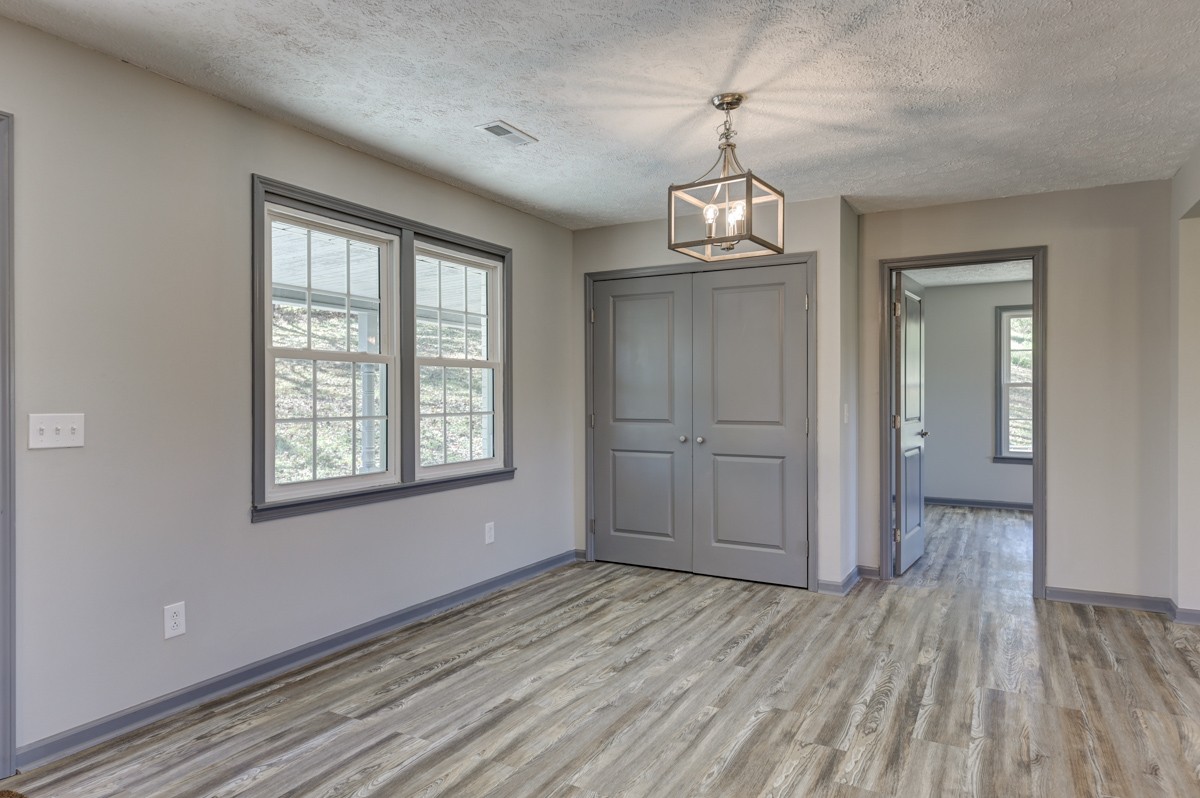 300 Garrison Branch Road Cottontown, TN 37048 - Photo 21 of 50 a view of empty room with wooden floor and window
