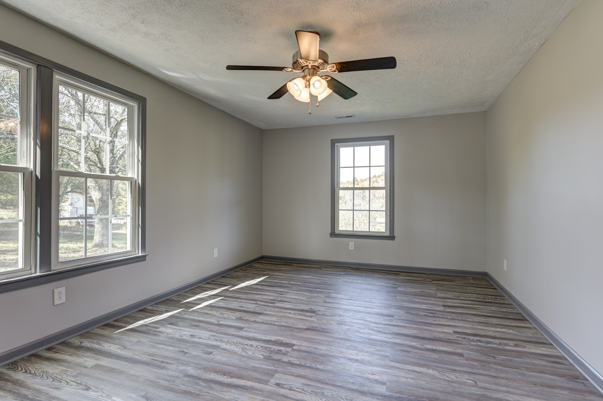 300 Garrison Branch Road Cottontown, TN 37048 - Photo 22 of 50 a view of an empty room with wooden floor and a window