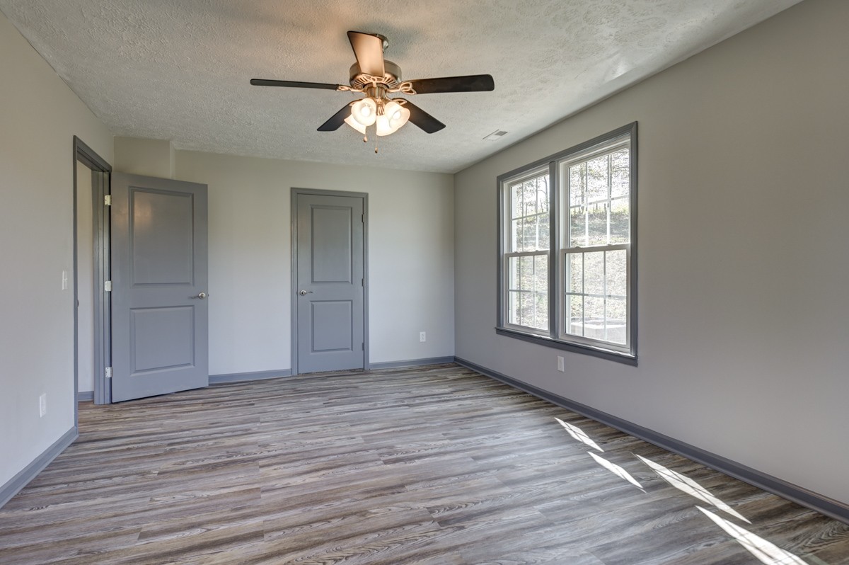 300 Garrison Branch Road Cottontown, TN 37048 - Photo 23 of 50 a view of an empty room with wooden floor and a window