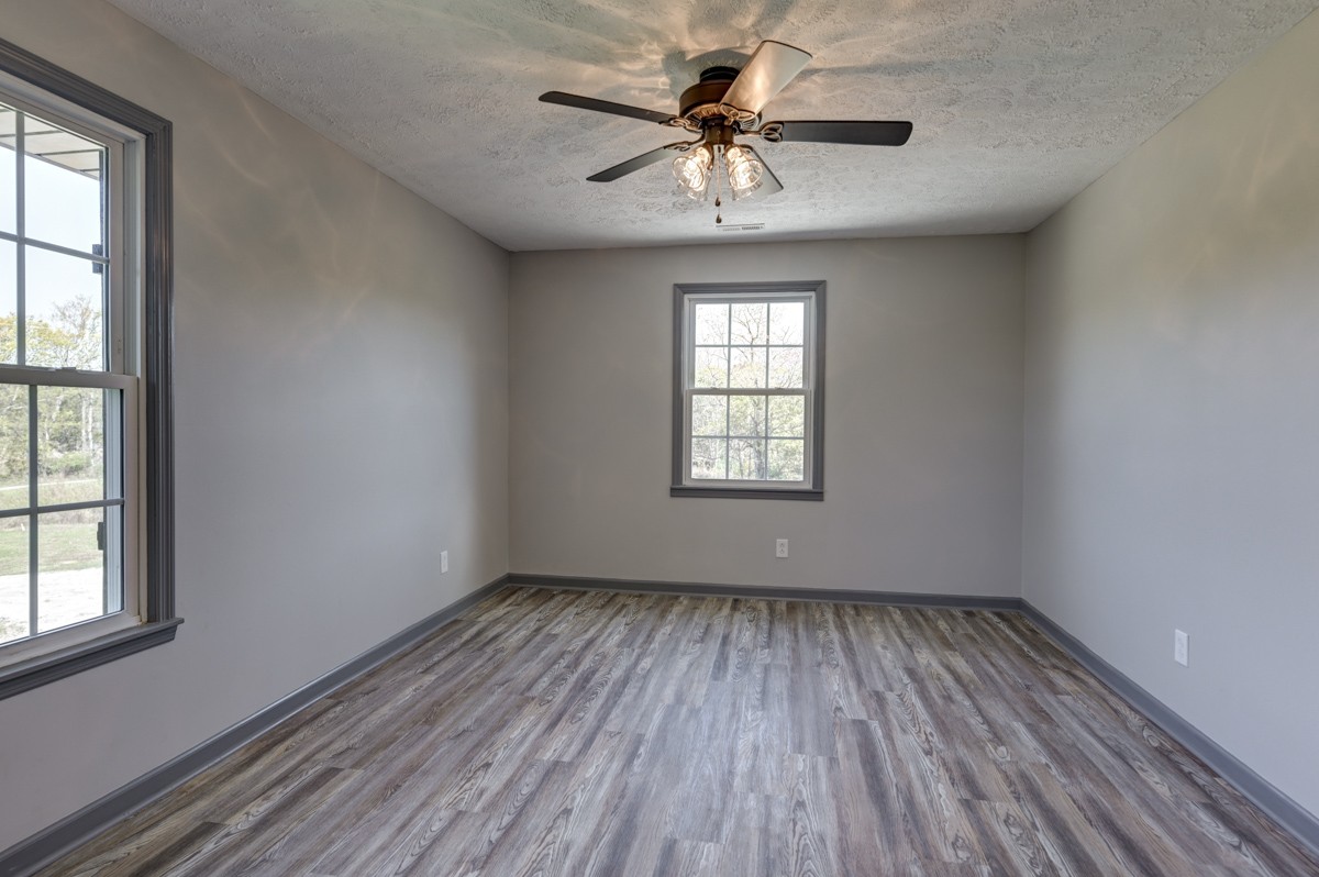 300 Garrison Branch Road Cottontown, TN 37048 - Photo 24 of 50 an empty room with windows and ceiling fan