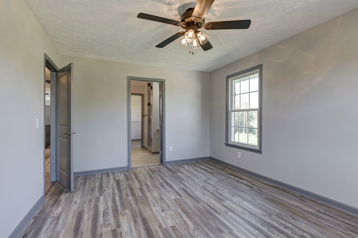 300 Garrison Branch Road Cottontown, TN 37048 - Photo 25 of 50 a view of empty room with wooden floor and fan