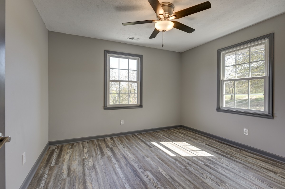 300 Garrison Branch Road Cottontown, TN 37048 - Photo 29 of 50 a view of empty room with wooden floor and fan