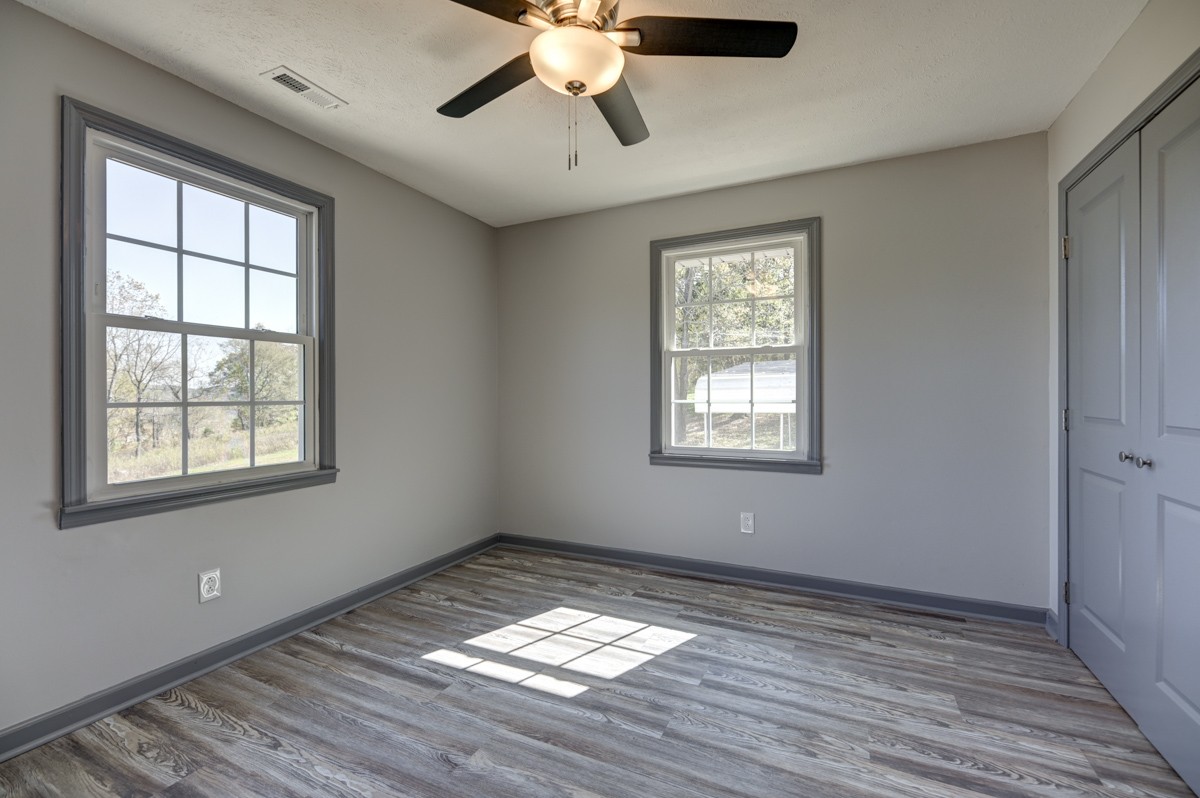 300 Garrison Branch Road Cottontown, TN 37048 - Photo 30 of 50 a view of empty room with wooden floor and fan