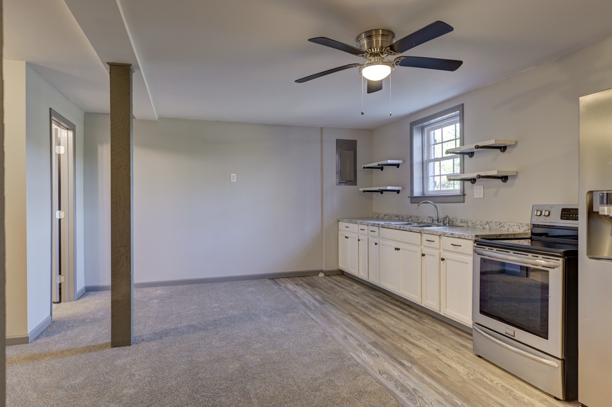 300 Garrison Branch Road Cottontown, TN 37048 - Photo 35 of 50 a kitchen with a stove a sink and a refrigerator
