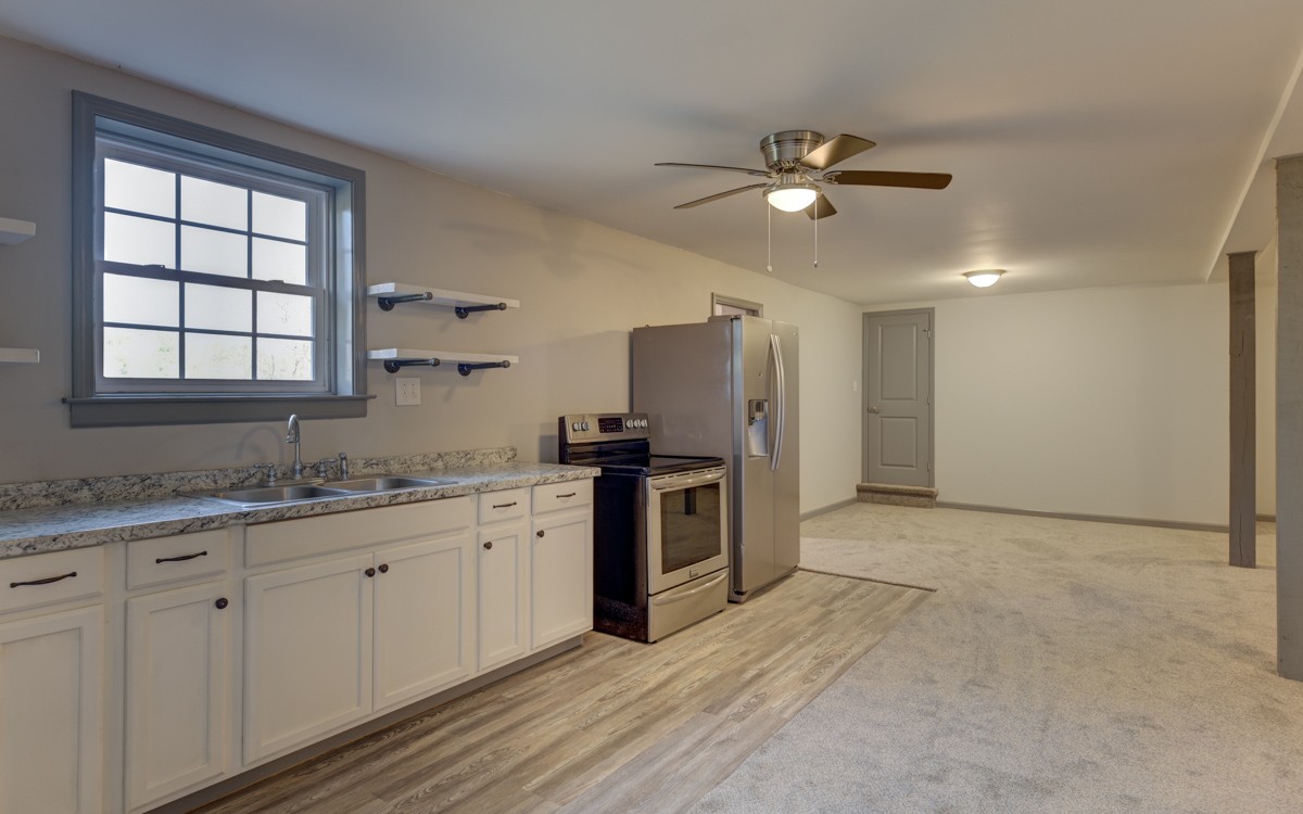300 Garrison Branch Road Cottontown, TN 37048 - Photo 36 of 50 a kitchen with granite countertop a sink stainless steel appliances and window