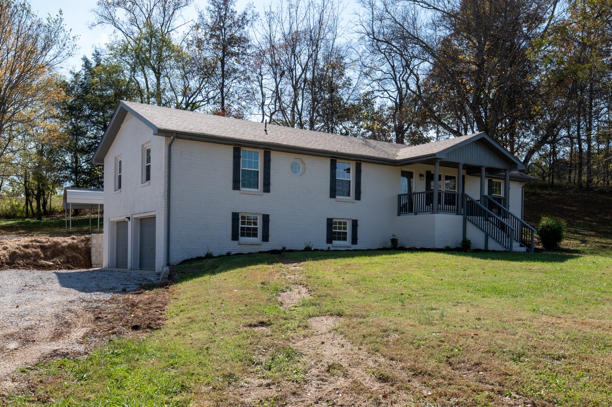 300 Garrison Branch Road Cottontown, TN 37048 - Photo 8 of 50 a front view of house with yard and trees in the background