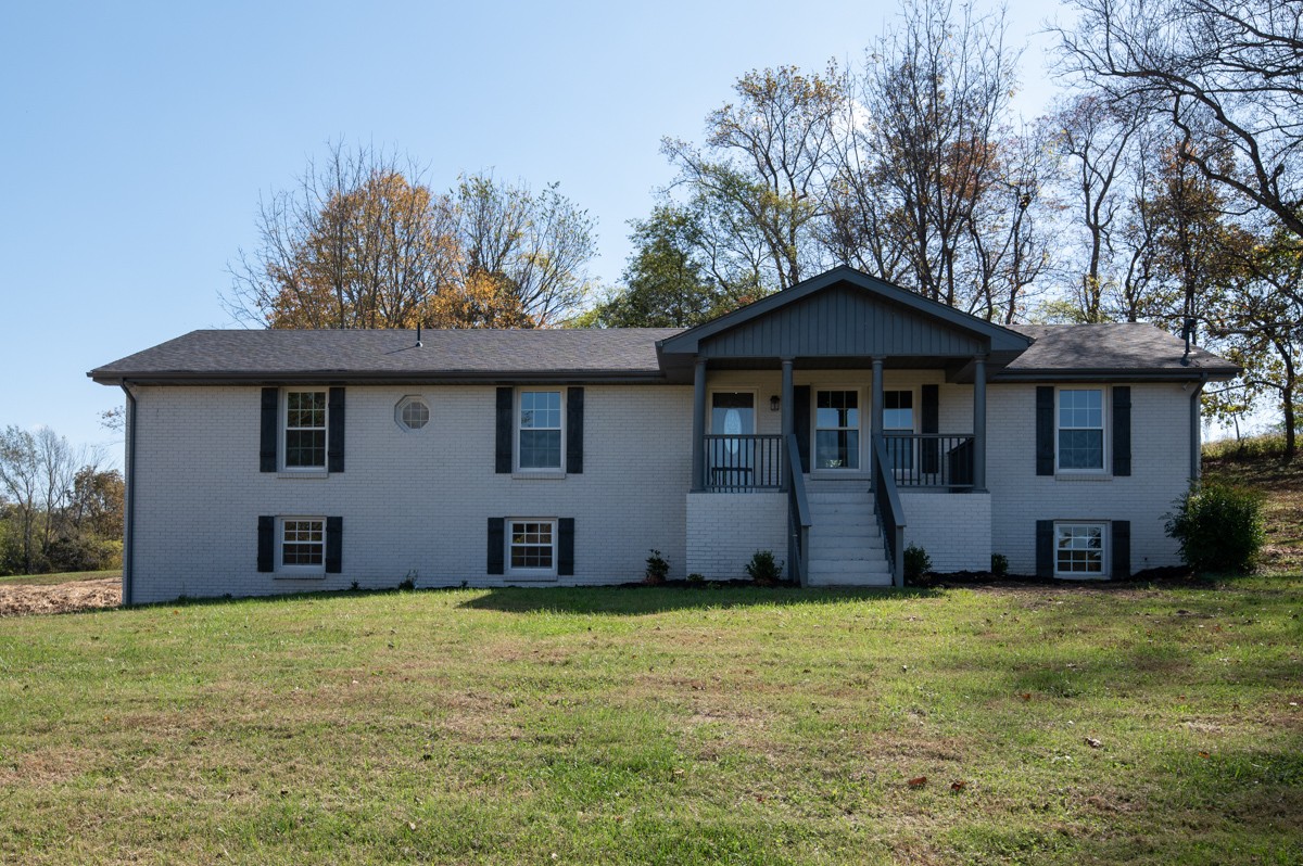 300 Garrison Branch Road Cottontown, TN 37048 - Photo 10 of 50 a front view of a house with a garden
