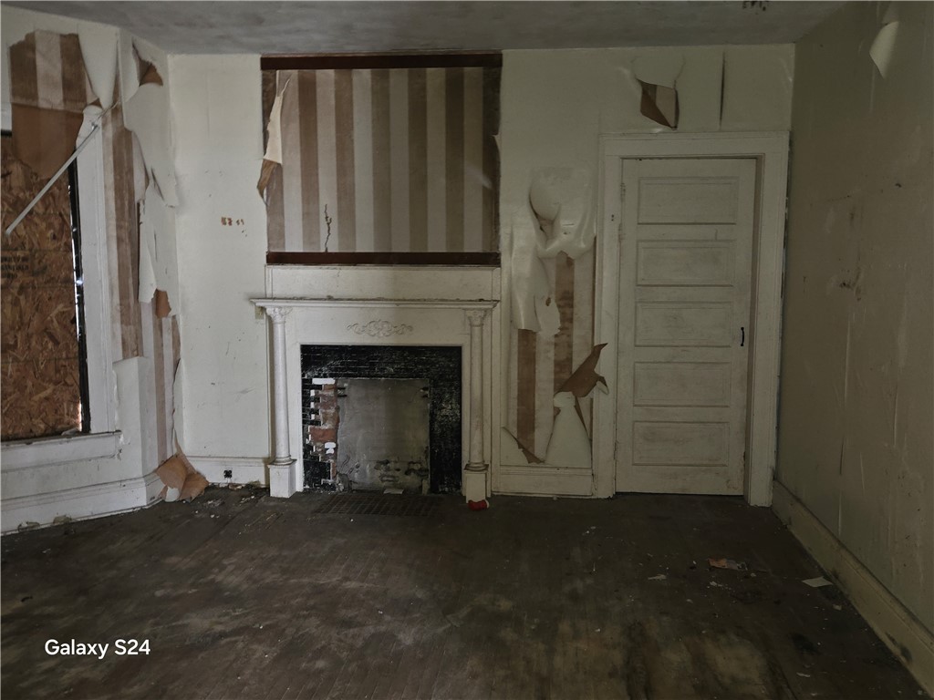 727 West High Street Springfield, OH 45506 - Photo 8 of 29 This living area features a classic fireplace and wooden floors, awaiting your creative vision.