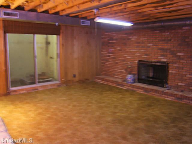 8805 Kings Tree Road Lewisville, NC 27023 - Photo 15 of 16 Playroom. Greenhouse Space and Fireplace! No Finished Ceiling.