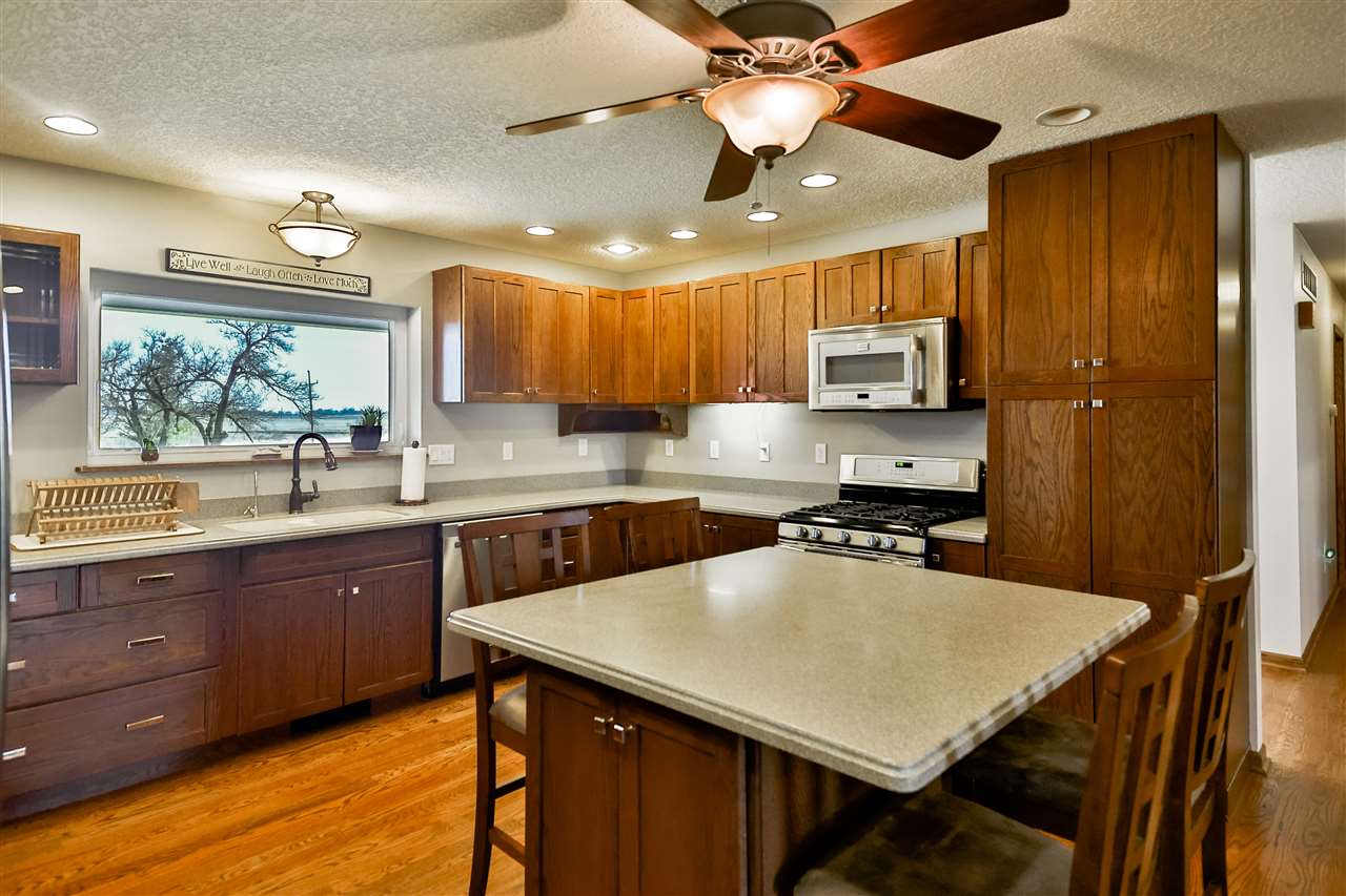 5776 Daysville Road Oregon, IL 61061 - Photo 15 of 34 a kitchen with a stove a sink a dining table and chairs