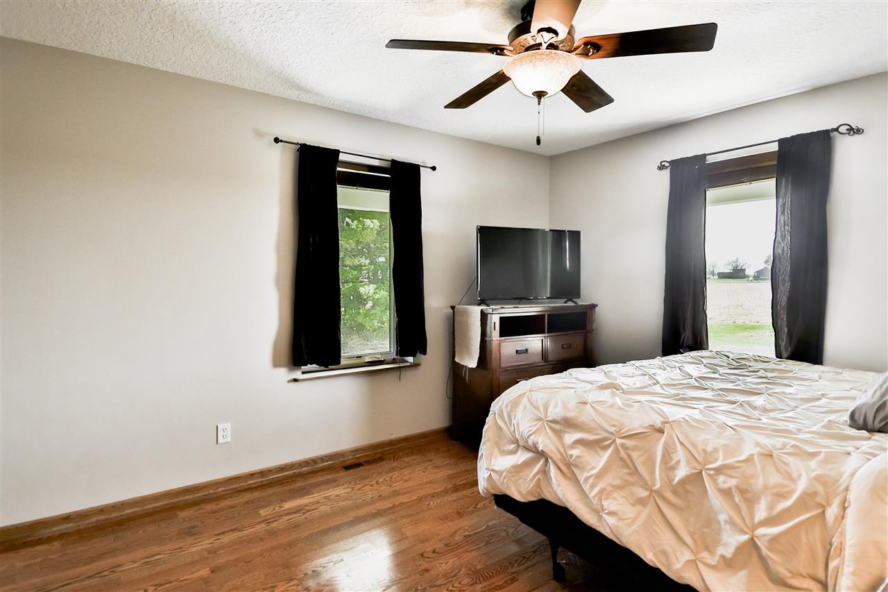 5776 Daysville Road Oregon, IL 61061 - Photo 22 of 34 a bedroom with a bed and a chandelier