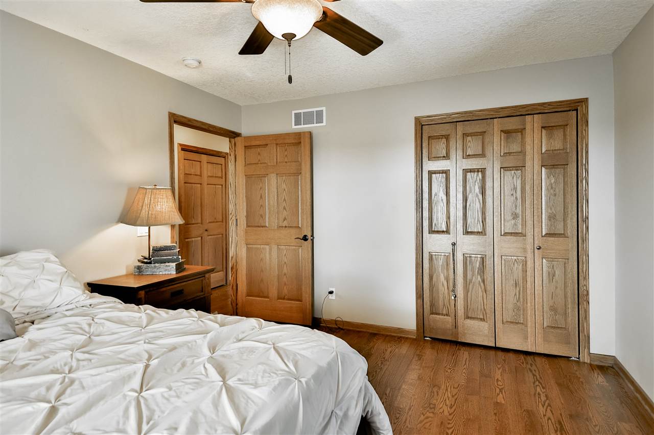 5776 Daysville Road Oregon, IL 61061 - Photo 24 of 34 a bedroom with a bed and a chandelier