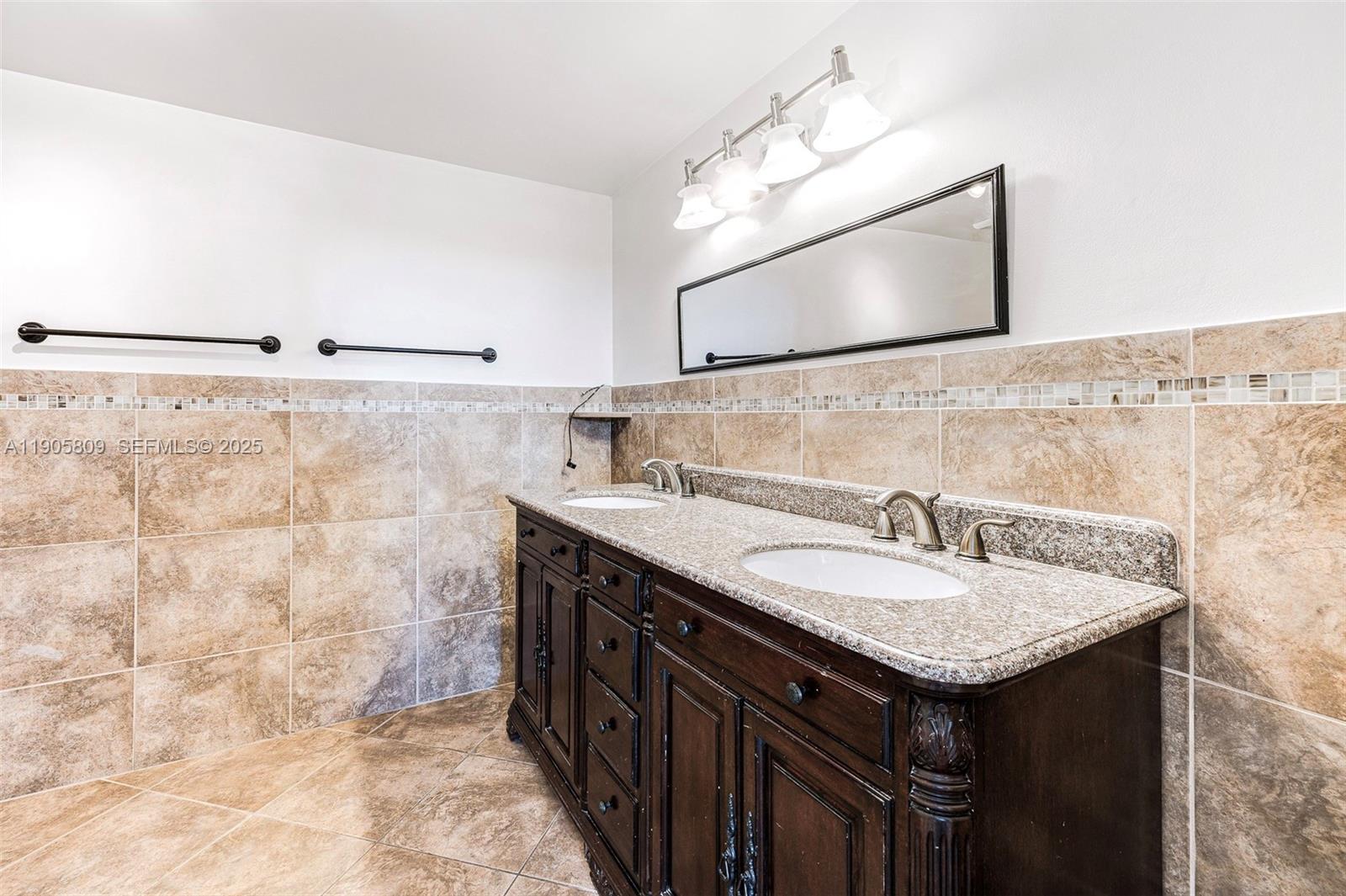 770 Northeast 199th Street, Unit 106F Miami, FL 33179 - Photo 18 of 25 a bathroom with a sink and a mirror