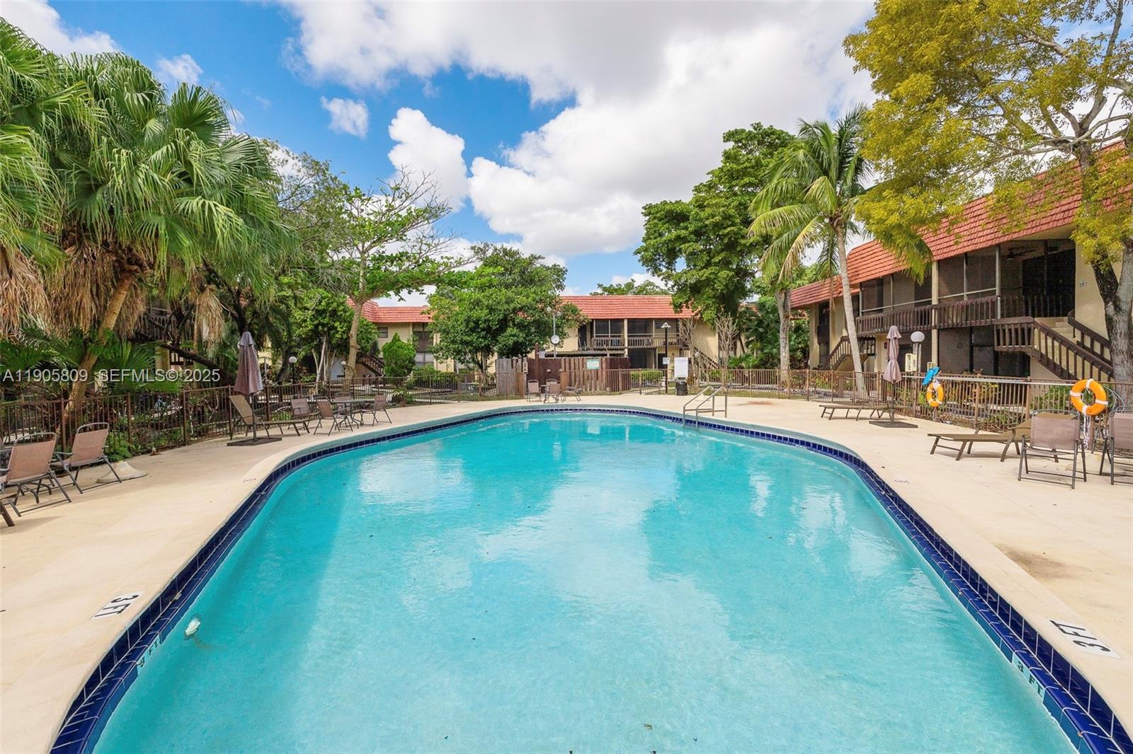 770 Northeast 199th Street, Unit 106F Miami, FL 33179 - Photo 23 of 25 a view of a swimming pool with a patio